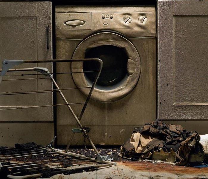 burned and melted washing machine, burned clothing and flooring