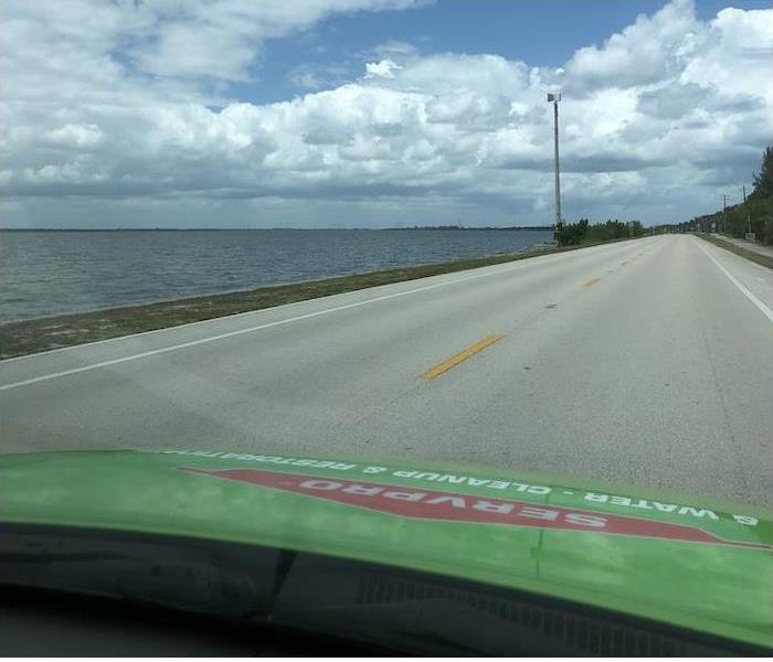 Hood of a SERVPRO car with the ocean in the distance